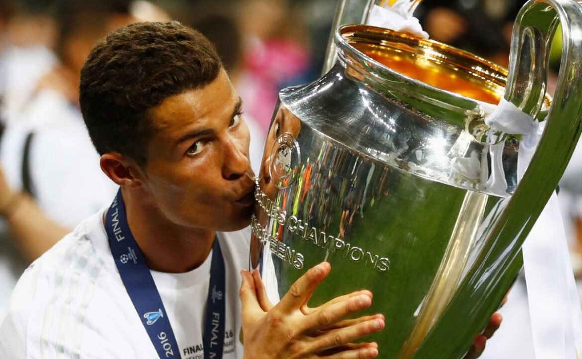 Cristiano Ronaldo holding Champions League trophies after winning UEFA titles